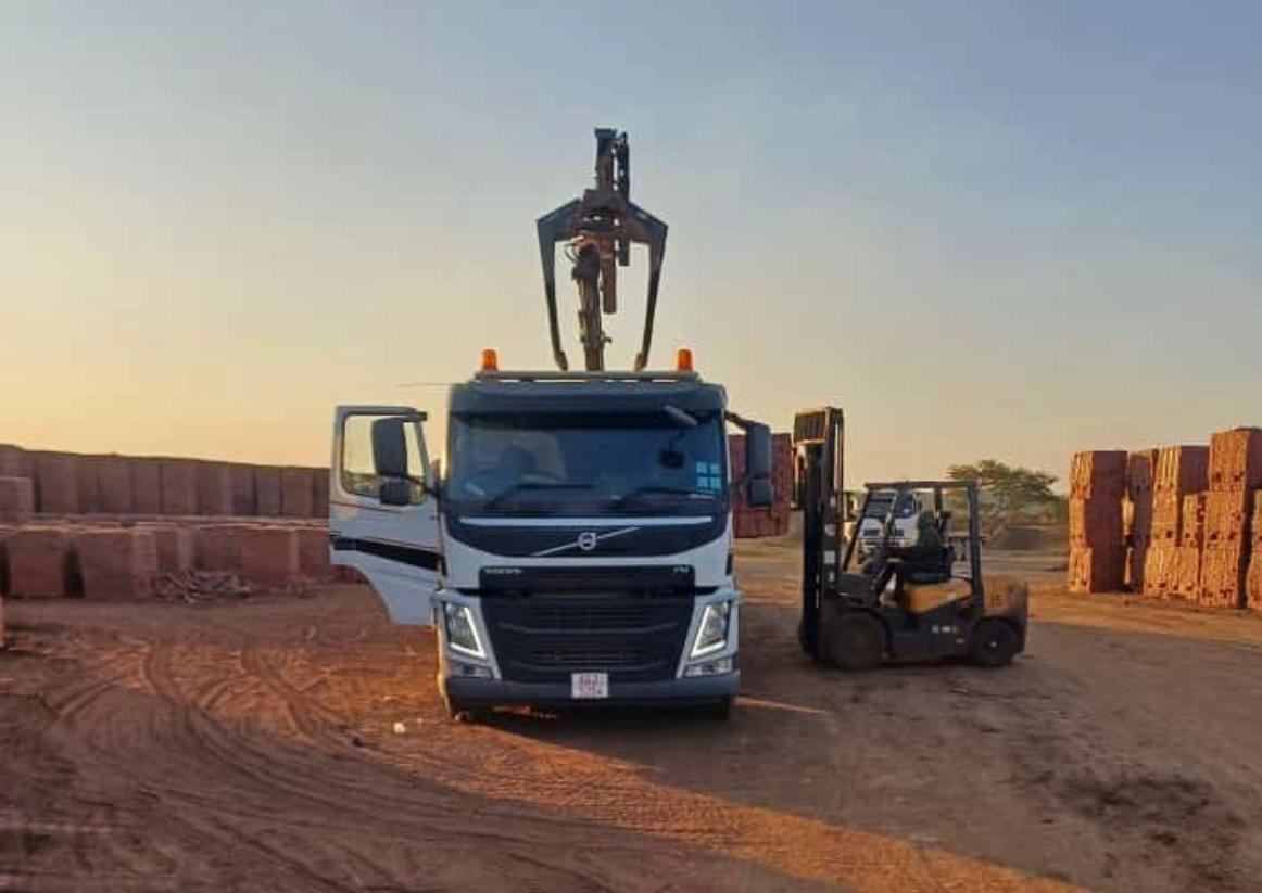 Hexham Express grab truck loading bricks at sunset